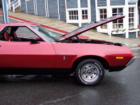 1972 Ford Ranchero - A red 1972 Ford Ranchero 500 is parked with its hood open, revealing the engine bay.