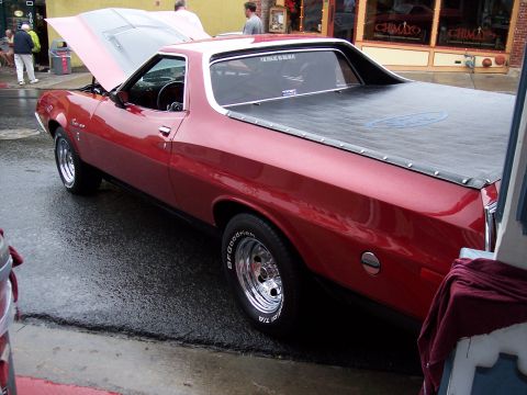 1972 Ford Ranchero - Red 1972 Ford Ranchero with hood open, parked on a wet street.