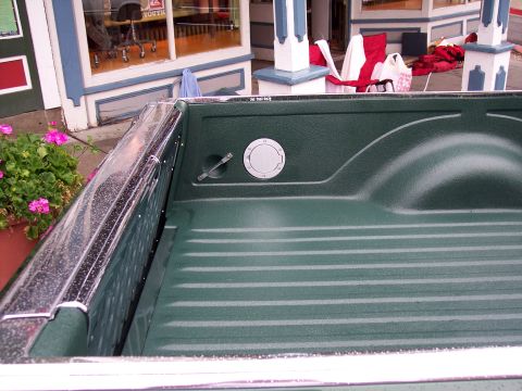 1972 Ford Ranchero - Close-up of a truck bed interior, focusing on the fuel filler access.