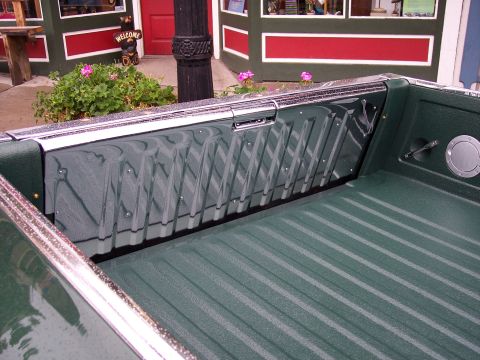 1972 Ford Ranchero - The interior of a pickup truck bed shows a textured green surface with chrome accents and a ribbed pattern.