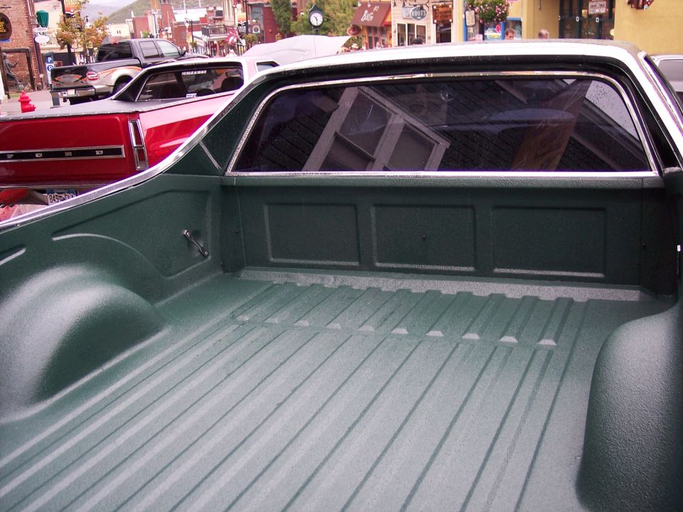 Green bedliner-coated Ranchero bed with rear cab window and chrome trim