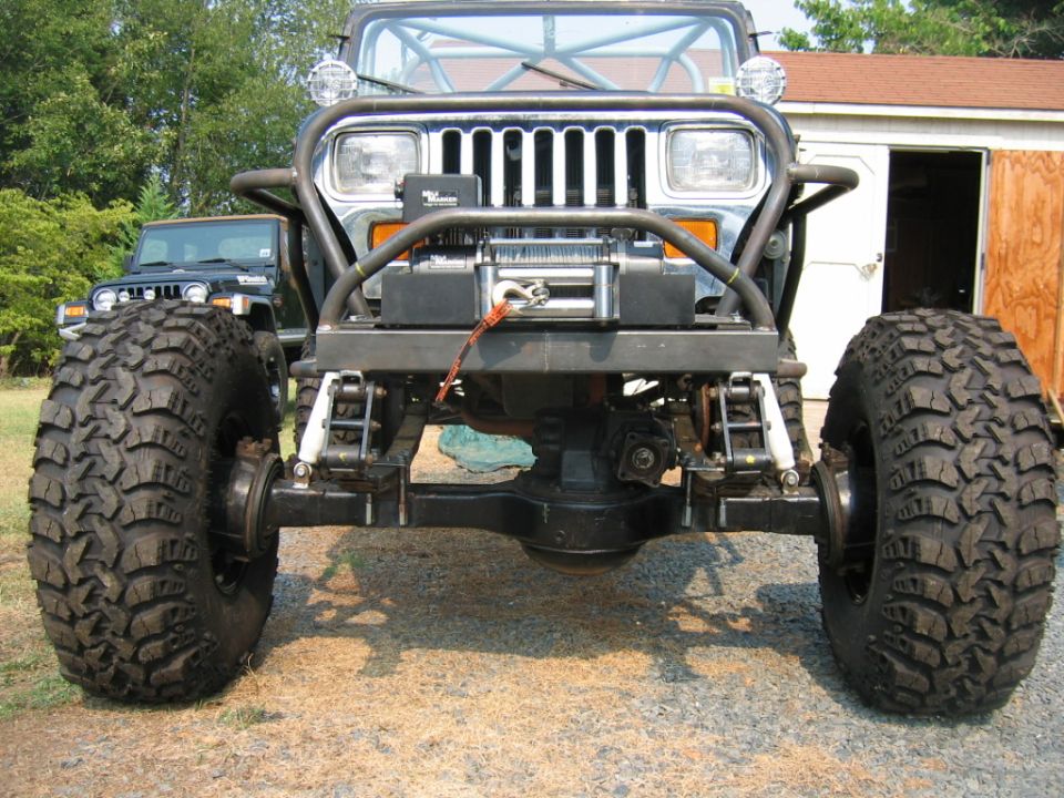 Front view of a modified Jeep Wrangler with large off-road tires and a winch