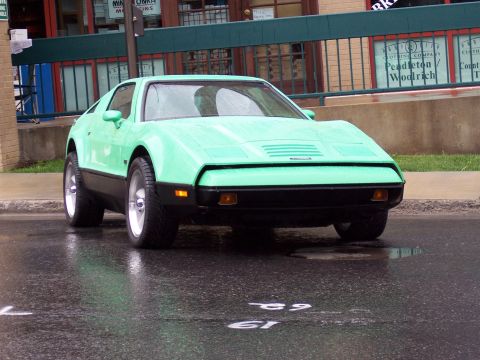 1972 Ford Ranchero - A mint green sports car with a distinctive front grille is seen from the front on a wet day.