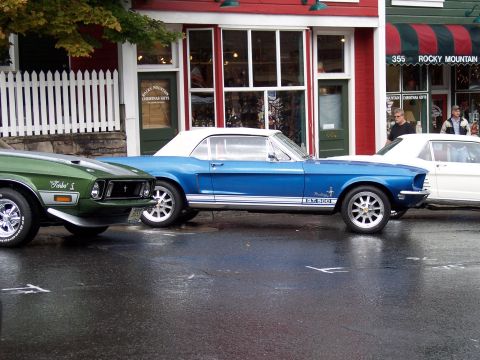 1972 Ford Ranchero - Blue 1968 Ford Mustang convertible and green 1971 Ford Falcon parked outside a shop.