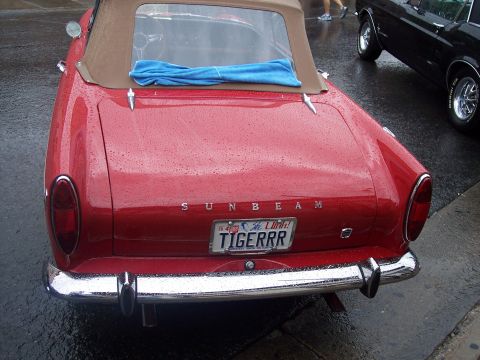 Rear of red Sunbeam convertible with tan top and Utah TIGERRR plate