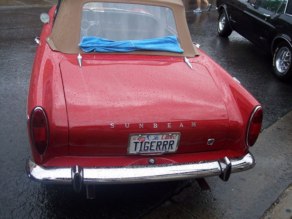 Rear of red Sunbeam convertible with tan top and Utah TIGERRR plate