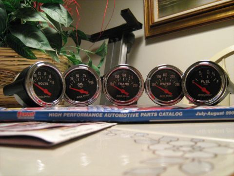 1988 Mercury Grand Marquis - A collection of AutoMeter gauges, including voltage, oil pressure, transmission temperature, water temperature, and fuel level, are display…