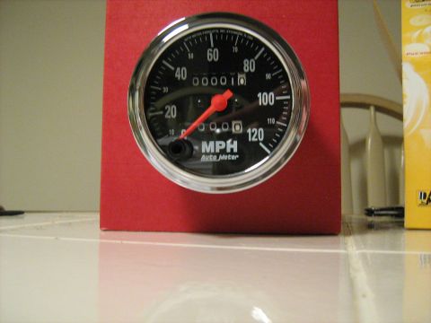 1988 Mercury Grand Marquis - An Auto Meter speedometer gauge is mounted on a red block, showing MPH.