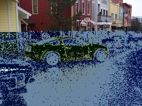 Corrupted side view of a car parked in front of colorful downtown storefronts