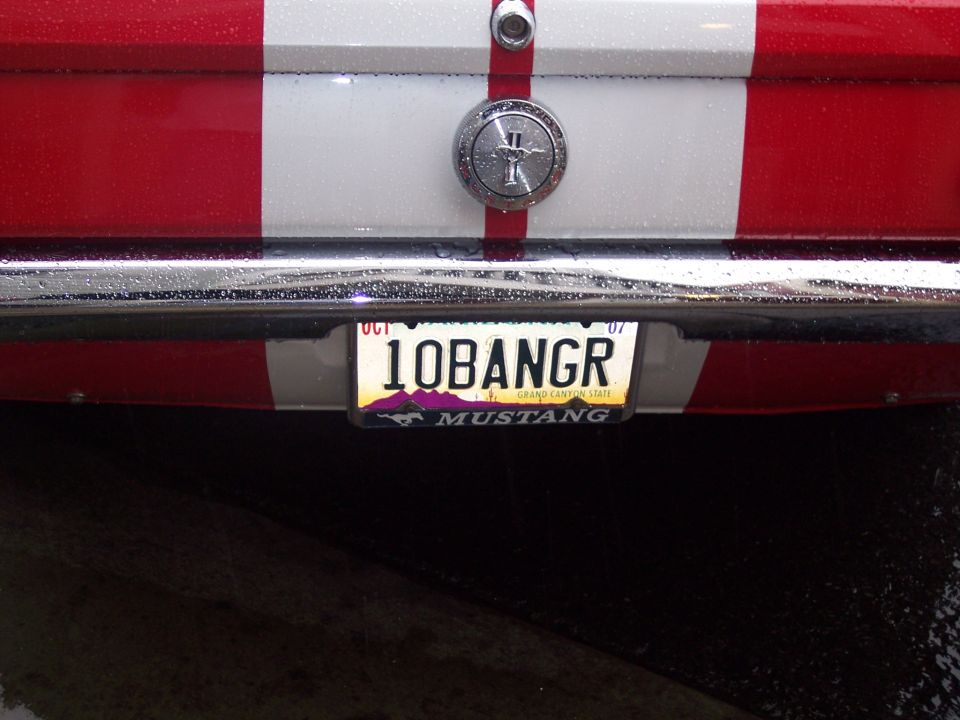 Rear plate '10BANGR' on red-white car with chrome bumper and Mustang frame