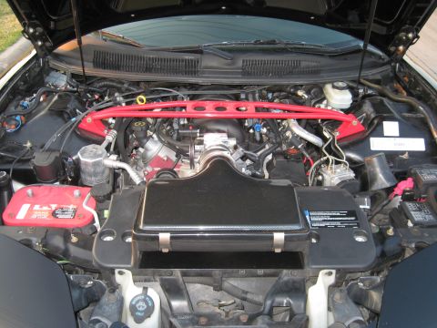 2002 Pontiac Trans Am - Car engine bay features a red strut bar and aftermarket air intake system.