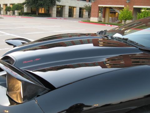2002 Pontiac Trans Am - Close-up of a black car's hood, showing the 'Ram Air' designation.