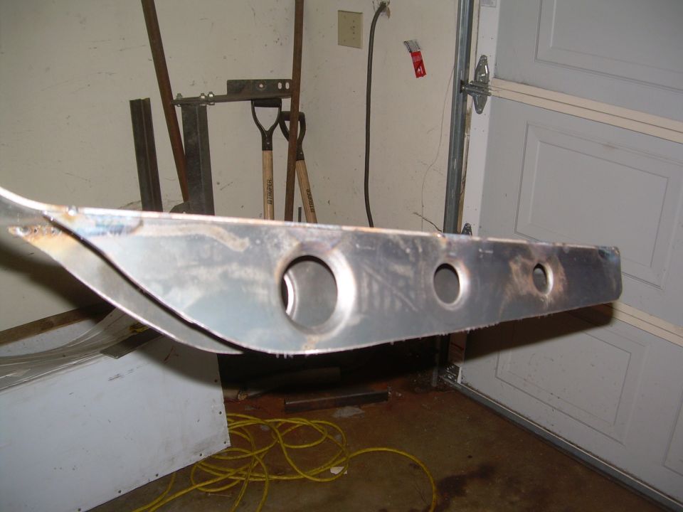 metal suspension part with holes, in a garage