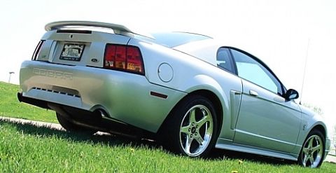 1998 Ford Taurus - Rear view of a silver Ford Mustang Cobra, showing its distinctive taillights and spoiler.