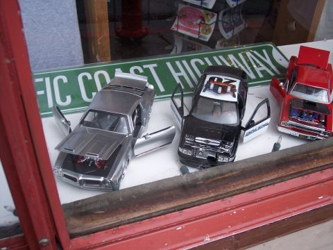 1972 Ford Ranchero - Model cars are displayed in a window with a Pacific Coast Highway sign in the background.