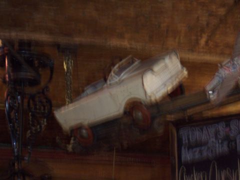 1972 Ford Ranchero - A blurry toy car hangs from the ceiling, its details obscured by motion.