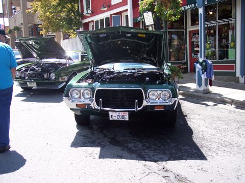 1972 Ford Ranchero - A green 1972 Ford Ranchero is displayed with its hood open, alongside another vehicle.
