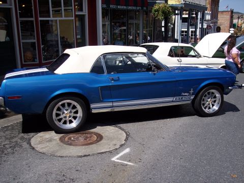 1972 Ford Ranchero - A blue 1967 Ford Mustang convertible with GT 500 badging is parked on a street next to another vehicle.