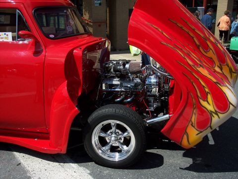 1972 Ford Ranchero - Custom hot rod with flame graphics and a powerful engine on display.