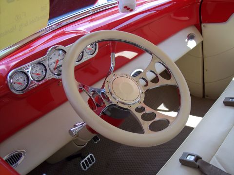 1972 Ford Ranchero - Custom car interior features a red dash, cream steering wheel, and aftermarket gauges.
