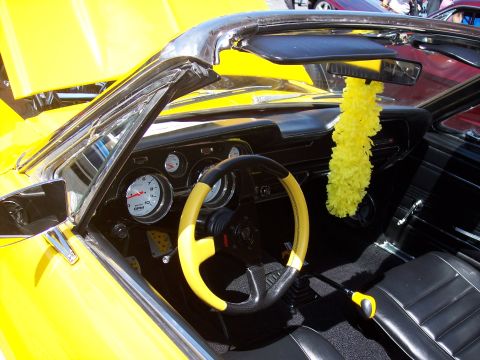 1972 Ford Ranchero - Interior view of a yellow convertible showing custom steering wheel and dashboard gauges.