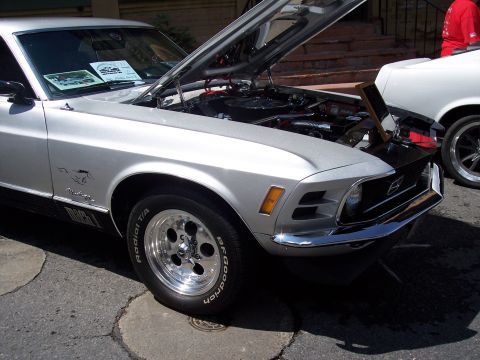 1972 Ford Ranchero - A silver 1970 Ford Mustang Mach 1 is parked next to a white vehicle, with its hood open.