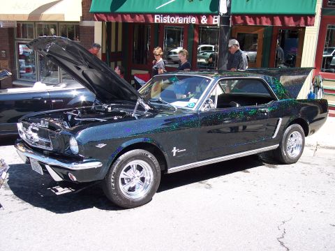 1972 Ford Ranchero - A classic black Ford Mustang with a sparkling paint job is displayed with its hood and trunk open.