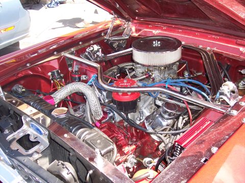 1972 Ford Ranchero - The engine bay of a classic car is detailed with chrome and performance parts.