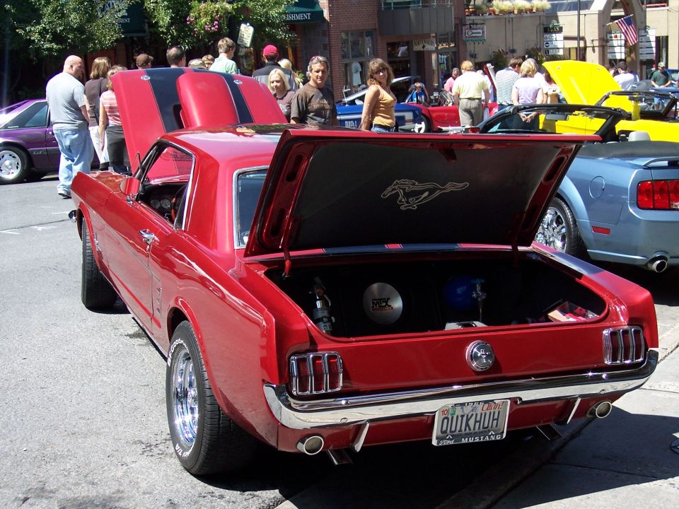 Red 1967 Ford Mustang coupe, rear view, trunk open showing a horse emblem