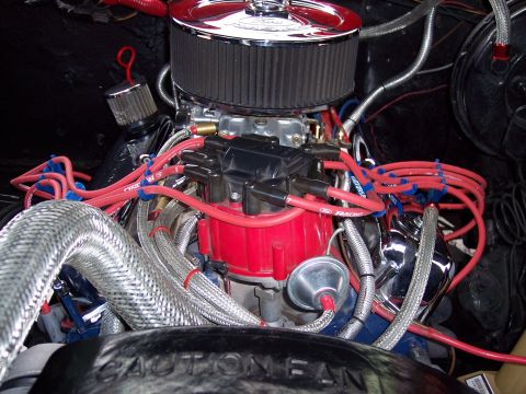 1972 Ford Ranchero - Close-up view of a modified engine bay, showing various components and wiring. Text on a black cover reads "CAUTION FAN".