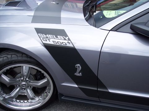 1972 Ford Ranchero - Side view of a silver Shelby GT500 showing the GT500+ stripe and cobra emblem.