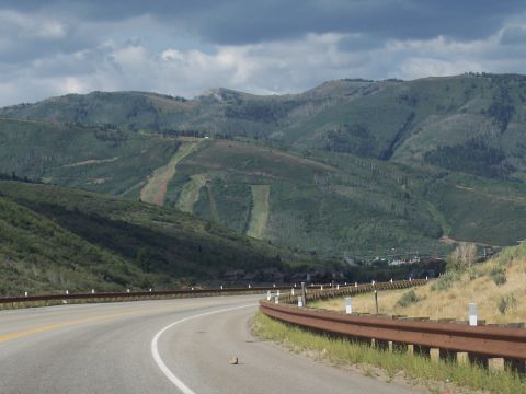 1972 Ford Ranchero - A scenic view of a mountain range with ski slopes visible, alongside a curving highway under a cloudy sky.
