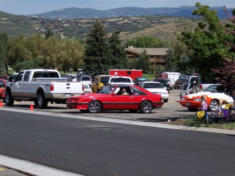 1972 Ford Ranchero - Several vehicles are parked in a lot with a scenic mountain backdrop.