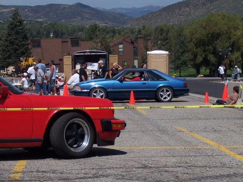 1972 Ford Ranchero - A blue coupe with a red interior is parked on a street with mountains in the background.