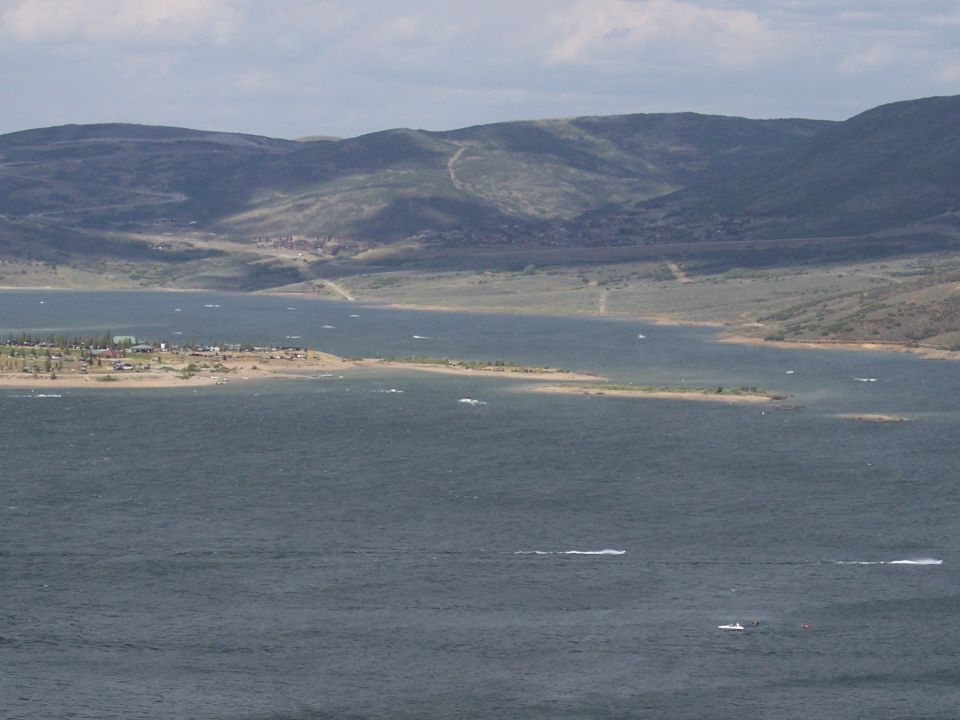 Lake with distant mountains and a small town on the shore