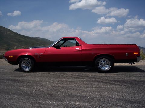 1972 Ford Ranchero - Side view of a red 1972 Ford Ranchero with chrome wheels and BFGoodrich tires.