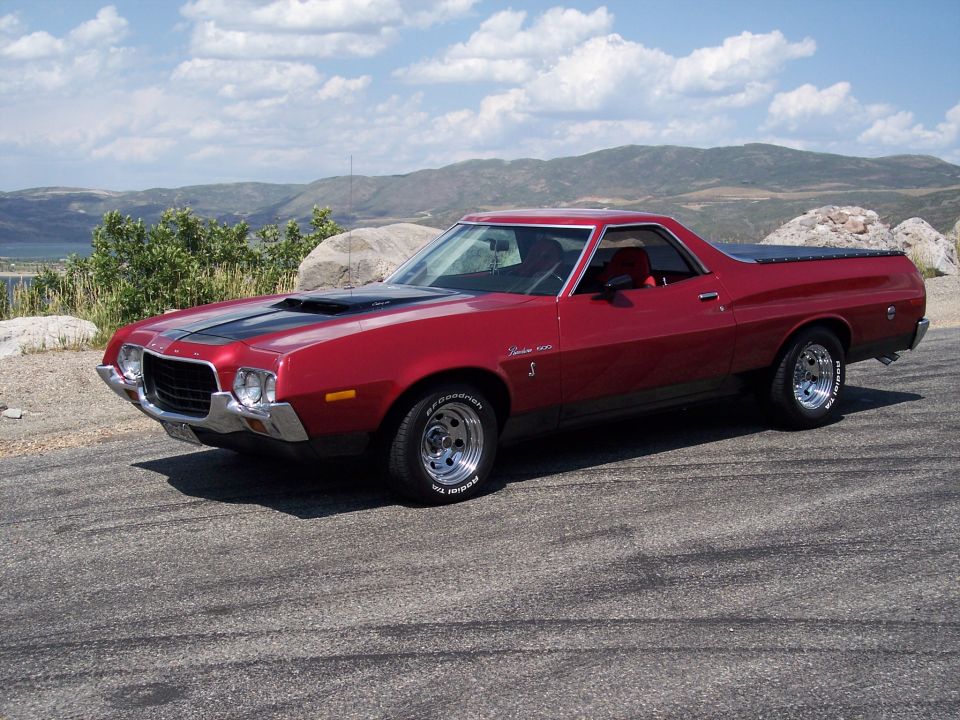Red 1972 Ford Ranchero with black racing stripes on hood