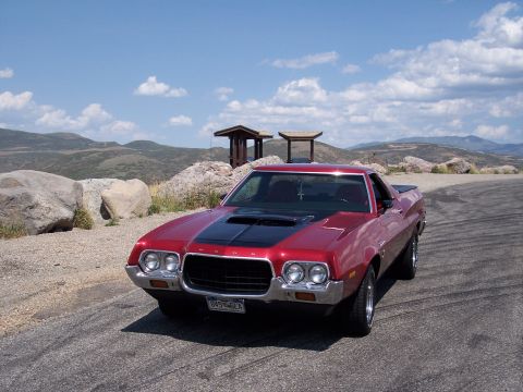 1972 Ford Ranchero - Red 1972 Ford Ranchero with black hood scoop parked on a scenic overlook.