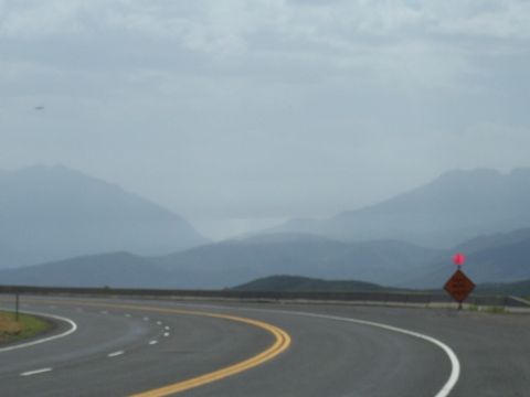 1972 Ford Ranchero - A highway curves through a mountainous landscape under an overcast sky.
