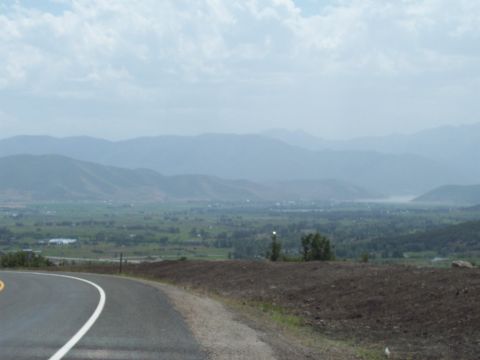 1972 Ford Ranchero - A scenic view of a valley and mountains, with a road curving into the foreground.