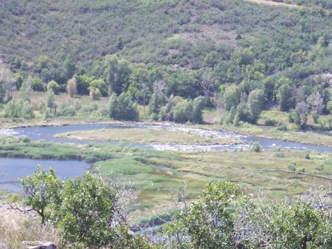 1972 Ford Ranchero - A scenic view of a river flowing through a lush, green valley under a clear sky.