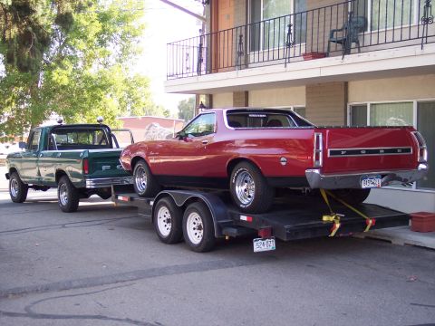 1972 Ford Ranchero - A 1972 Ford Ranchero is transported on a trailer by a green Ford pickup truck.