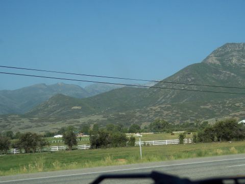 1972 Ford Ranchero - A scenic view of rolling hills and mountains, with a white fence line in the foreground.