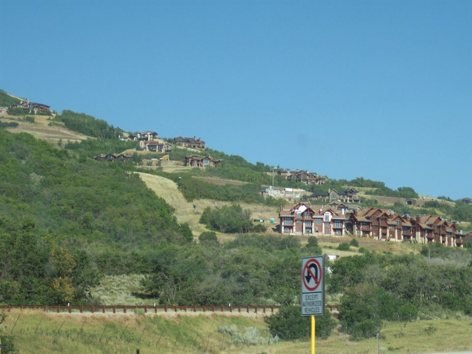 Mountainous landscape with houses and a no U-turn sign