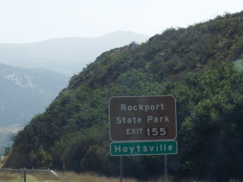 1972 Ford Ranchero - Signs indicate an exit for Rockport State Park and Hoytsville, set against a backdrop of hills and mountains.