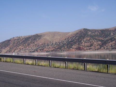 1972 Ford Ranchero - A roadside view captures a tranquil lake reflecting the sky, with arid hills in the background.