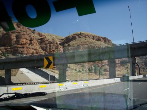 1972 Ford Ranchero - A highway scene with a concrete overpass and mountains under a clear blue sky.