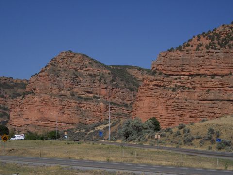 1972 Ford Ranchero - A scenic view of a canyon landscape with a highway running through it, under a bright blue sky.
