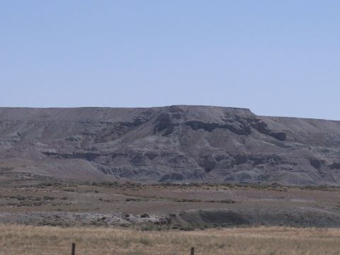 1972 Ford Ranchero - A vast expanse of eroded hills and dry grass stretches under a cloudless sky.