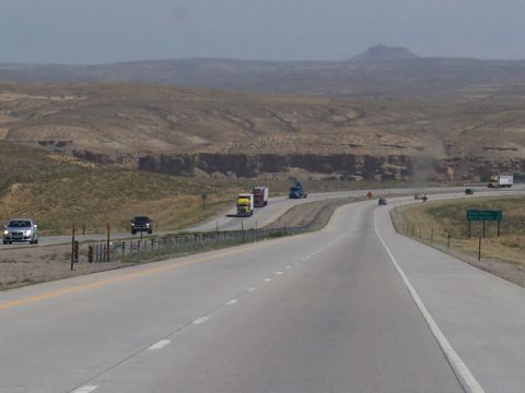 1972 Ford Ranchero - Vehicles travel on a highway through a dry, hilly landscape under a hazy sky.
